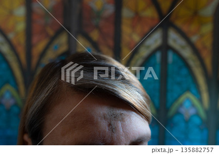 Ash Wednesday celebrations in church on stained glass window. 135882757