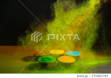 colorful rainbow holi paint color powder explosion isolated on dark black background. colorful rainbow holi paint color powder explosion isolated on dark black background. 135882762