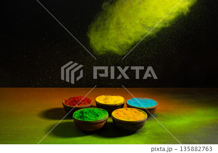 colorful rainbow holi paint color powder explosion isolated on dark black background. colorful rainbow holi paint color powder explosion isolated on dark black background. 135882763