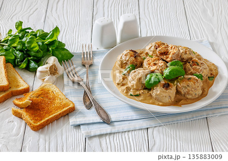 Chicken meatballs in creamy sun dried tomato sauce 135883009