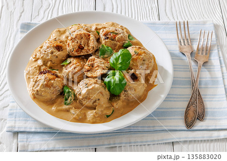 Chicken meatballs in creamy sun dried tomato sauce 135883020