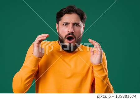 Stressed Mature Man In Panic And Disbelief On Green.Guy with eyes full of horror Stressed Mature Man In Panic And Disbelief On Green.Guy with eyes full of horror 135883374