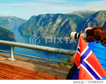 Tourist over fjord with camera, Norway Tourist over fjord with camera, Norway 135883833