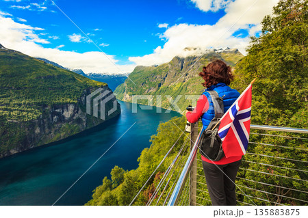 Tourist taking photo of fjord landscape, Norway Tourist taking photo of fjord landscape, Norway 135883875