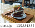 Coffee and chocolate cake with ice coffee in coffee shop. 135884285