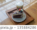 Coffee and chocolate cake with ice coffee in coffee shop. 135884286