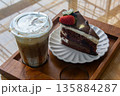 Coffee and chocolate cake with ice coffee in coffee shop. 135884287