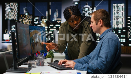 Diverse team of engineers using artificial intelligence to design a floor plan, working together with neural networks and computer aided apartment layout on architectural software. Camera B. 135884414