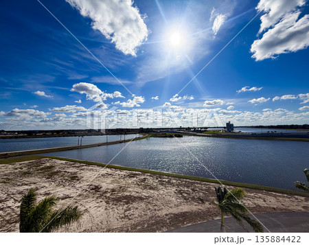 Bright Sun Over Coastal Lagoon and Blue Sky Bright Sun Over Coastal Lagoon and Blue Sky 135884422