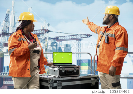 Green screen mockup laptop used by offshore platform workers to track emissions, protecting environment. Specialists conduct environmental risk assessment for drilling rig using chroma key notebook Green screen mockup laptop used by offshore platform workers to track emissions, protecting environment. Specialists conduct environmental risk assessment for drilling rig using chroma key notebook 135884462