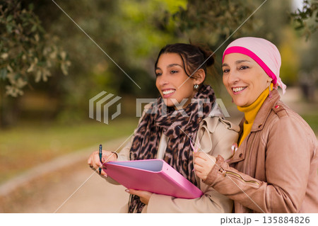 Women volunteers collecting signatures for breast cancer awareness Women volunteers collecting signatures for breast cancer awareness 135884826