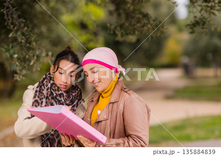 Women volunteers collecting signatures for breast cancer awareness 135884839