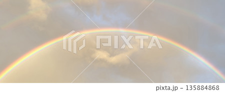 Bright rainbow appears after a light afternoon rain 135884868