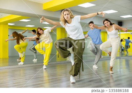 Teenage girl training breakdance Footwork moves in dance hall 135886188