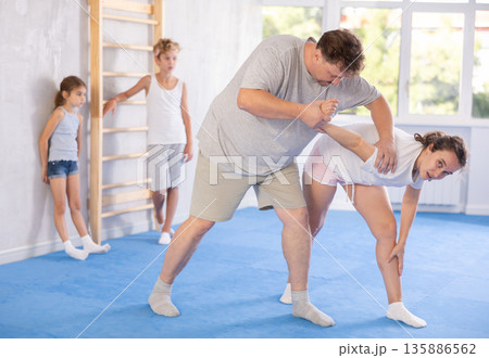 Man and woman training self-defense techniques 135886562