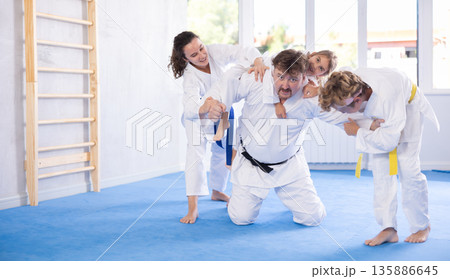 Family with children training karate fighting techniques Family with children training karate fighting techniques 135886645