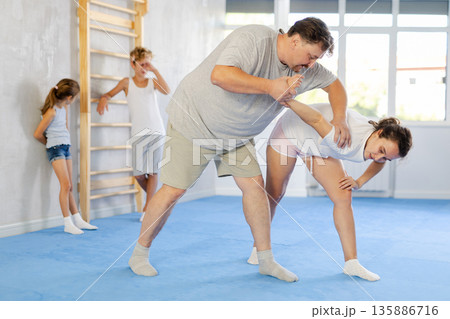 Man and woman training self-defense techniques Man and woman training self-defense techniques 135886716