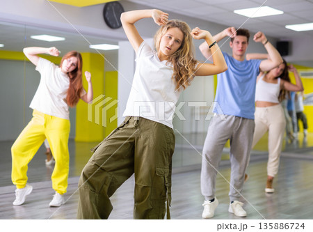 Boys and girls learn to dance dances in dance studio Boys and girls learn to dance dances in dance studio 135886724