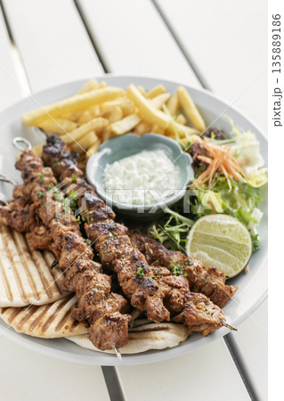 BBQ chicken skewer gyros plate on white table in mykonos  restaurant greece 135889186