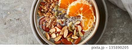 An energizing breakfast bowl packed with proteinrich chia seeds juicy oranges and a mix of crunchy almonds and pumpkin seeds 135890205
