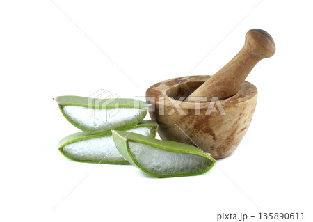 Aloe vera slices with rustic mortar on white background Aloe vera slices with rustic mortar on white background 135890611
