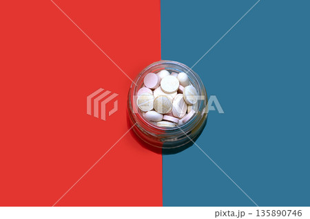 Dual personality pills in glass jar Dual personality pills in glass jar 135890746