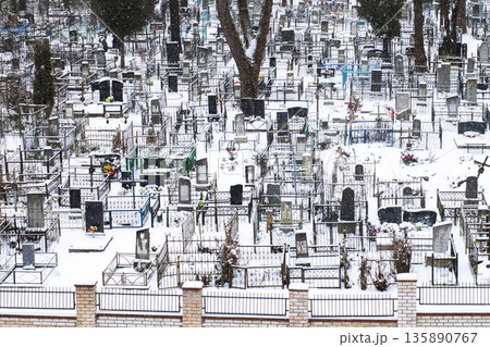 Frozen cemetery with solemn atmosphere, Snowladen resting place exudes quiet reflection Frozen cemetery with solemn atmosphere, Snowladen resting place exudes quiet reflection 135890767