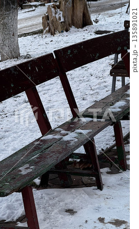 Rustic bench covered in snow, surrounded by nature. Rustic bench covered in snow, surrounded by nature. 135891021