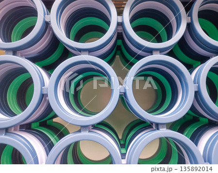 Symmetrical Top View of Stacked Blue and Green Plastic Rings for Home Organization 135892014