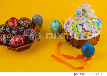 Celebration with decorated eggs and cake at Easter time 135892112