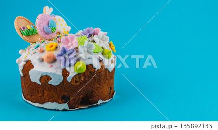 Easter cake with colorful decoration on blue background Easter cake with colorful decoration on blue background 135892135