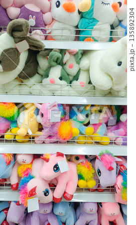 Colorful Unicorn and Rabbit Plush Toys on Retail Display Shelf Colorful Unicorn and Rabbit Plush Toys on Retail Display Shelf 135892304