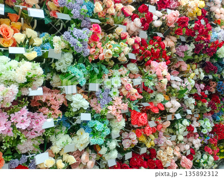 Wall of Colorful Artificial Flower Bouquets for Interior Design 135892312