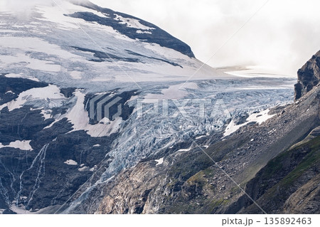 Majestic Glacier Landscape Awe-Inspiring Mountain Ice Formation under Cloudy Skies Majestic Glacier Landscape Awe-Inspiring Mountain Ice Formation under Cloudy Skies 135892463