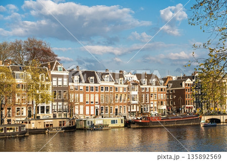 Amsterdam s Historic Canals Charming Canal Houses and Barges along the Waterway in Netherlands Amsterdam s Historic Canals Charming Canal Houses and Barges along the Waterway in Netherlands 135892569