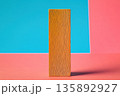 Simple wooden block stands against colorful background in minimalistic design 135892927