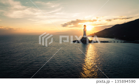 Guanyin statue at seaside in nanshan temple, hainan island , China. Words mean mercy and blessing. 135894590