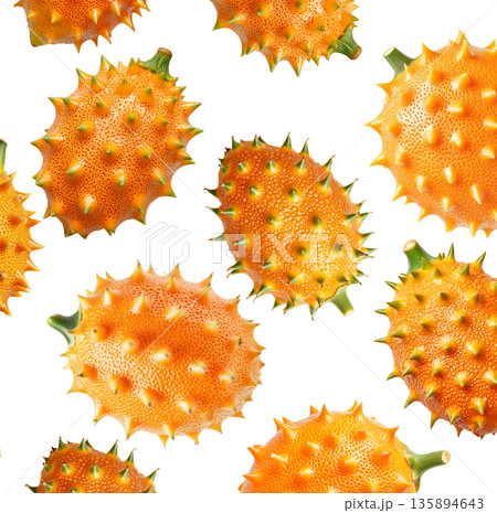 Multiple horned orange kiwano fruits with green tips isolated on white background, concept of exotic fruit freshness Multiple horned orange kiwano fruits with green tips isolated on white background, concept of exotic fruit freshness 135894643