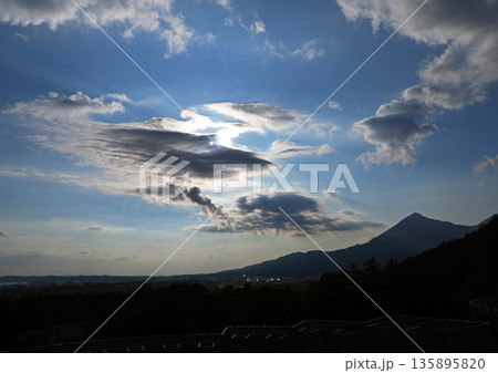 初夏の午後、シルエットの磐梯山と雲で白く輝く太陽とのコラボレーションが印象的で綺麗だ。 初夏の午後、シルエットの磐梯山と雲で白く輝く太陽とのコラボレーションが印象的で綺麗だ。 135895820