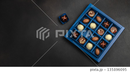 Luxury chocolate pralines gift box with single candy and copy space Luxury chocolate pralines gift box with single candy and copy space 135896095