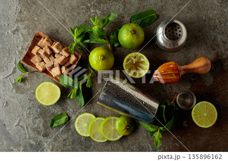 Wooden citrus squeezer, shaker, and ingredients for making summer refreshing drinks. 135896162