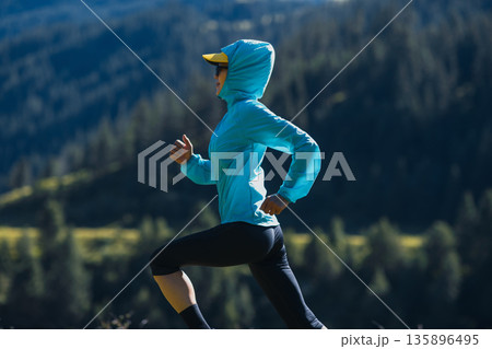 Fitness asian woman runner running at sunrise grassland 135896495