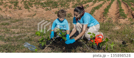 Family helping planting tree in garden for save world on wind turbine field background 135898528