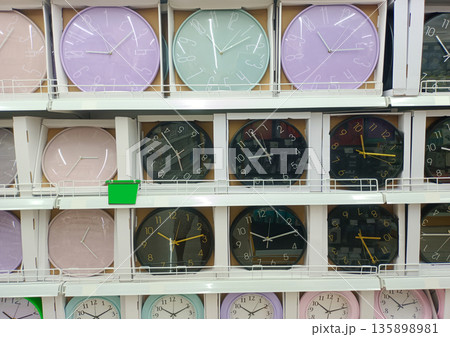 Modern Wall Clocks Display in Various Pastel Colors on Retail Store Shelf Modern Wall Clocks Display in Various Pastel Colors on Retail Store Shelf 135898981