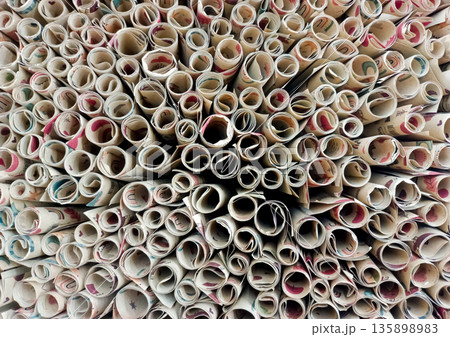 Top View of Multiple Rolled Paper Sheets with Decorative Patterns and Designs 135898983