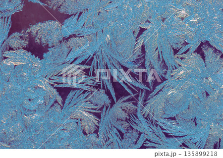 Natural ice texture on the frozen window in colorful light. Gradient color. Christmas background Natural ice texture on the frozen window in colorful light. Gradient color. Christmas background 135899218