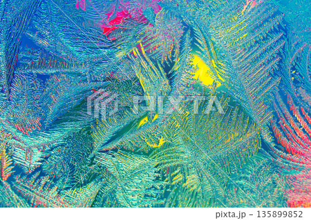 Photo of natural colorful ice texture with light on the frozen glass. Abstract background Photo of natural colorful ice texture with light on the frozen glass. Abstract background 135899852