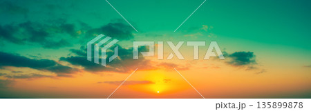 Cloudy sky at sunset. Cloudy sky background. Horizontal banner 135899878
