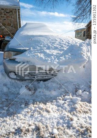 Siilver car buried in snow in rural setting blue sky winter scene copy space Siilver car buried in snow in rural setting blue sky winter scene copy space 135901302