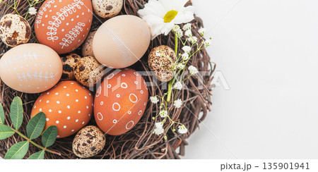 Easter nest with hand-painted eggs on a light background Easter nest with hand-painted eggs on a light background 135901941
